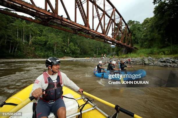Participants take part in a massive navigation down the Pacuare River, in Siquirres, Limon, Costa Rica, on October 11 as part of the closing activity...