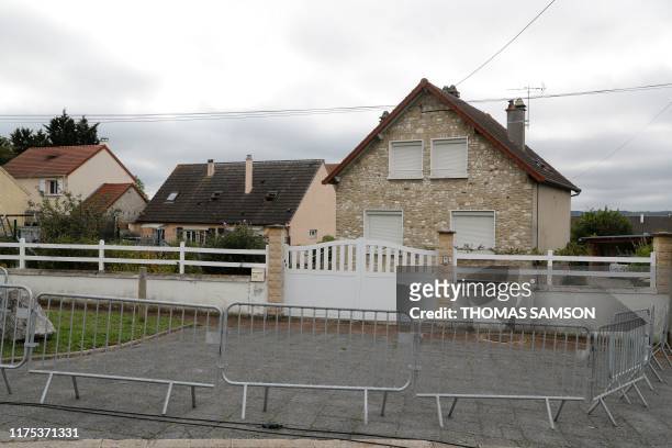 This photograph taken on October 12 shows barriers placed at the front of a house in Limay, north-west of Paris, which is said to be the home of a...