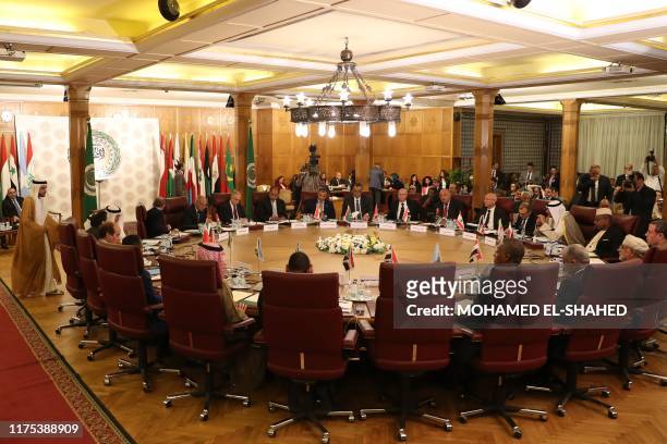 Representatives of the League of Arab states attend an emergency meeting at the Arab League headquarters in Cairo on October 12 to discuss Turkey's...