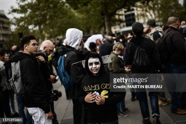Enthusiast dressed as zombies takes part in the Zombie Walk event on the Place de la Republique in Paris, on October 12, 2019.