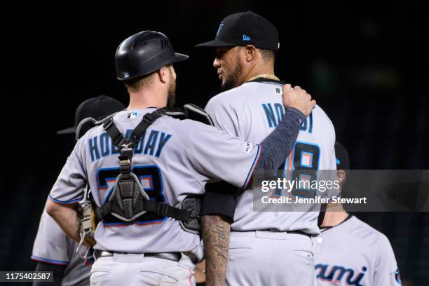 Bryan Holaday and Hector Noesi of the Miami Marlins celebrate after closing out the MLB game against the Arizona Diamondbacks at Chase Field on...