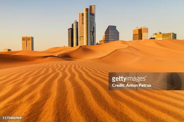 conceptual image of a metropolis with skyscrapers in the desert - qatar stock pictures, royalty-free photos & images