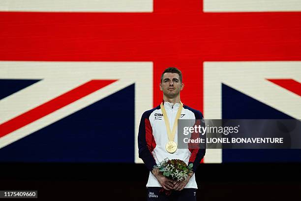 World Champion Great Britain's Max Whitlock poses on the podium during the medal ceremony for the pommel horse event after the apparatus finals at...