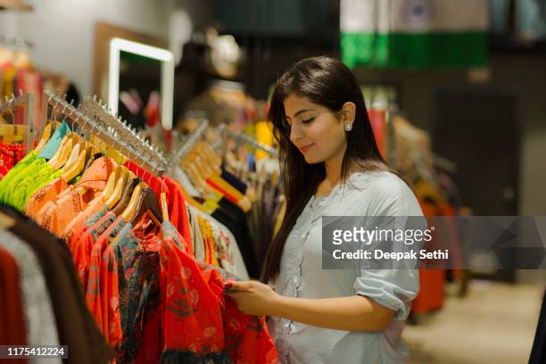 woman buying clothes at department store. stock photo - shop stock pictures, royalty-free photos & images