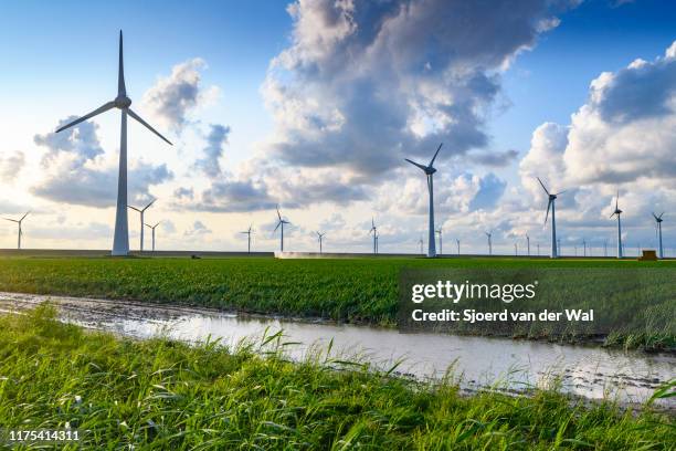 wind turbines on a levee in a windpark during a summer sunset - ijsselmeer stock pictures, royalty-free photos & images