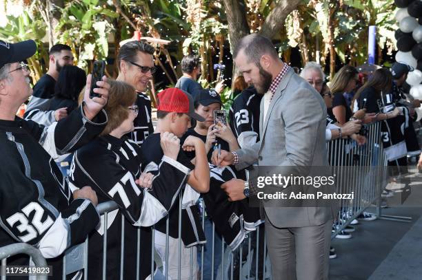 Kyle Clifford of the Los Angeles Kings autographs jerseys before the Los Angeles Kings game against the Nashville Predators at STAPLES Center on...