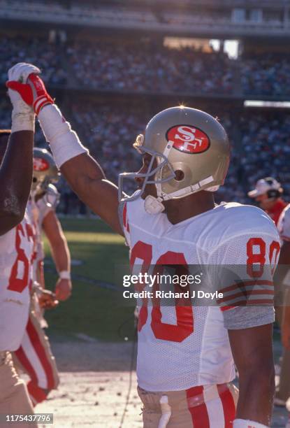 Jerry Rice high fives RG Guy McIntyre on the sidelines. San Francisco 49ers 48 vs San Diego Chargers 10 at Jack Murphy Stadium in San Diego,...