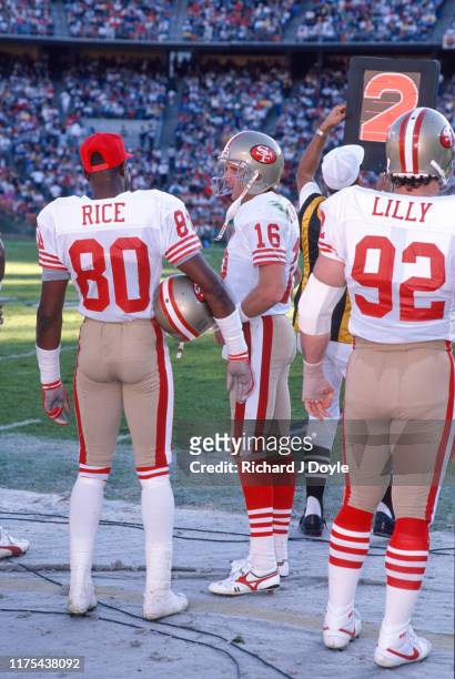Joe Montana, WR Jerry Rice and DE Kevin Lilly on the sidelines. San Francisco 49ers 48 vs San Diego Chargers 10 at Jack Murphy Stadium in San Diego,...