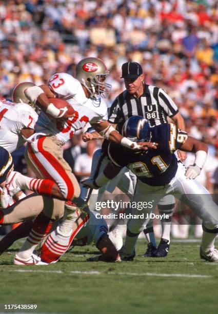 Roger Craig attempts to escape tackle by S.D. Chargers - DE Leslie O'Neal. San Francisco 49ers 48 vs San Diego Chargers 10 at Jack Murphy Stadium in...