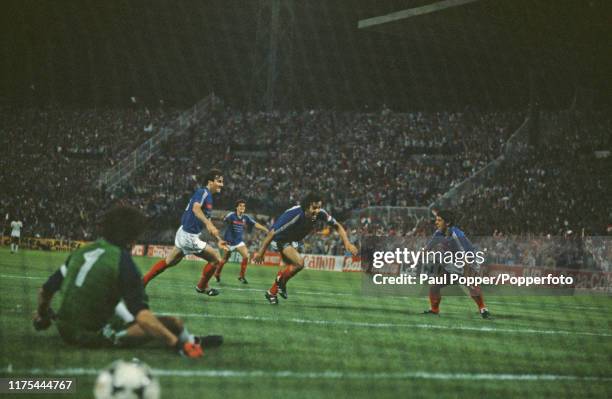 French professional footballer Michel Platini throws his arms out wide after scoring the winning goal for the France national team after 119 minutes...