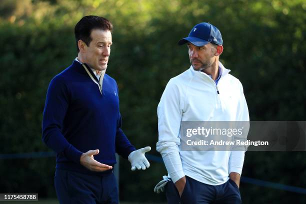 Anton du Beke speaks with Andriy Shevchenko during the Pro-Am tournament prior to the start of the BMW PGA Championship at Wentworth Golf Club on...