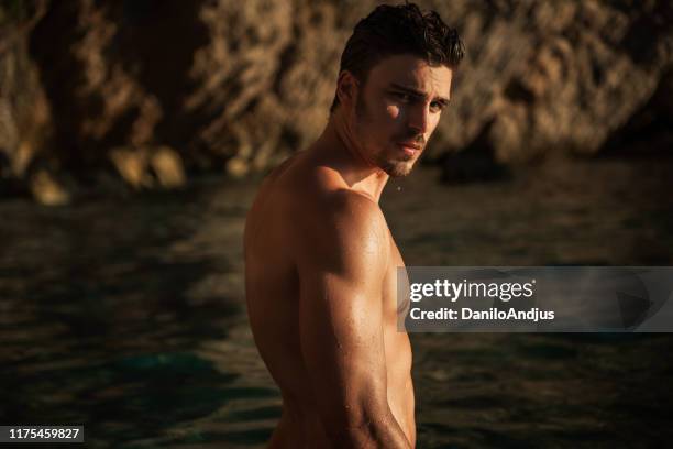 sexy man on the beach in summer - hot body stock pictures, royalty-free photos & images