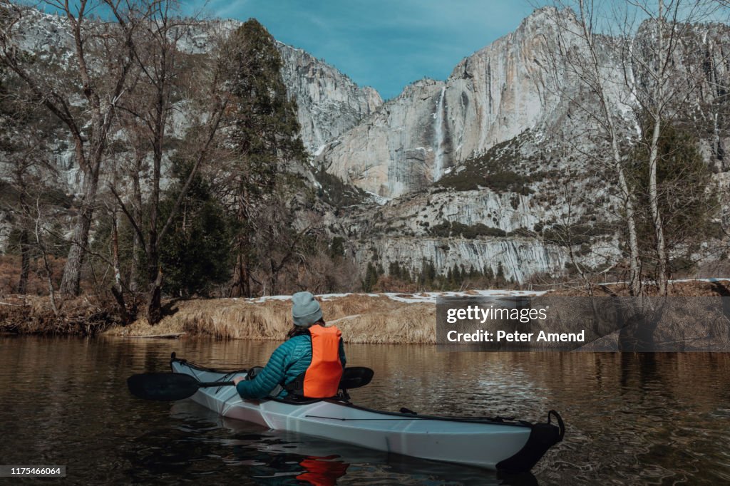 Man kayaking in lake, Yosemite Village, California, United States