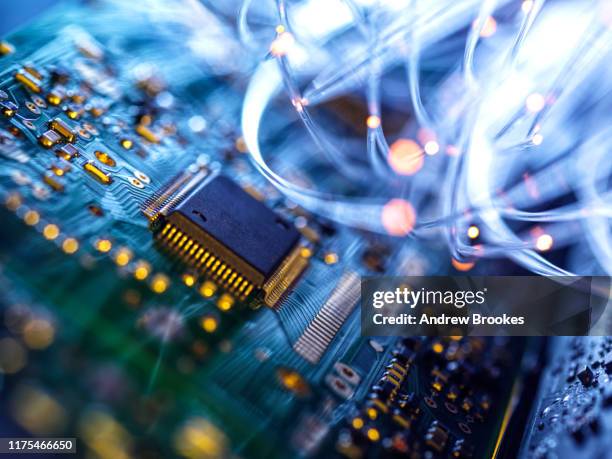 fibre optics carrying data passing through electronic circuit boards, close up - electronic ストックフォトと画像