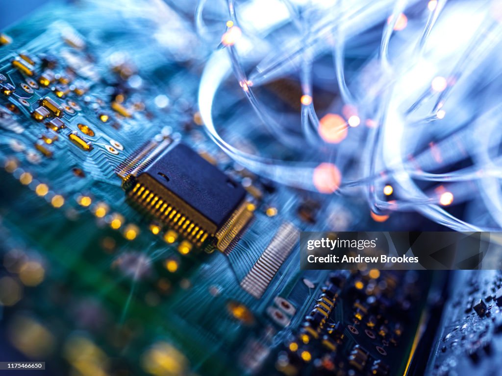Fibre optics carrying data passing through electronic circuit boards, close up
