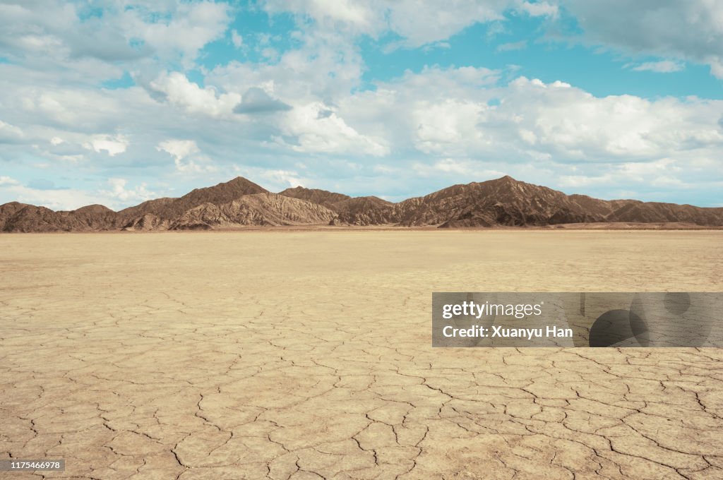 Cracked land with arid mountains