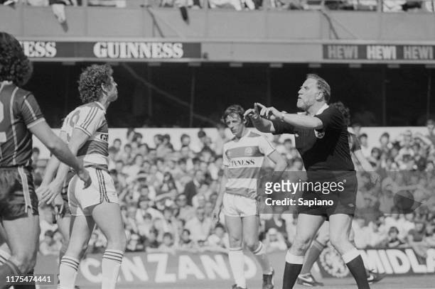 English soccer player Clive Allen talks to the referee during Queens Park Rangers v Leicester City match, London, UK, 21st April 1984.