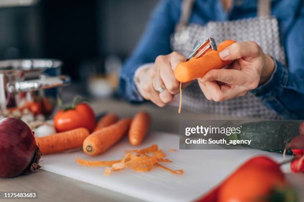 lady peeling a carrot - peel stock pictures, royalty-free photos & images