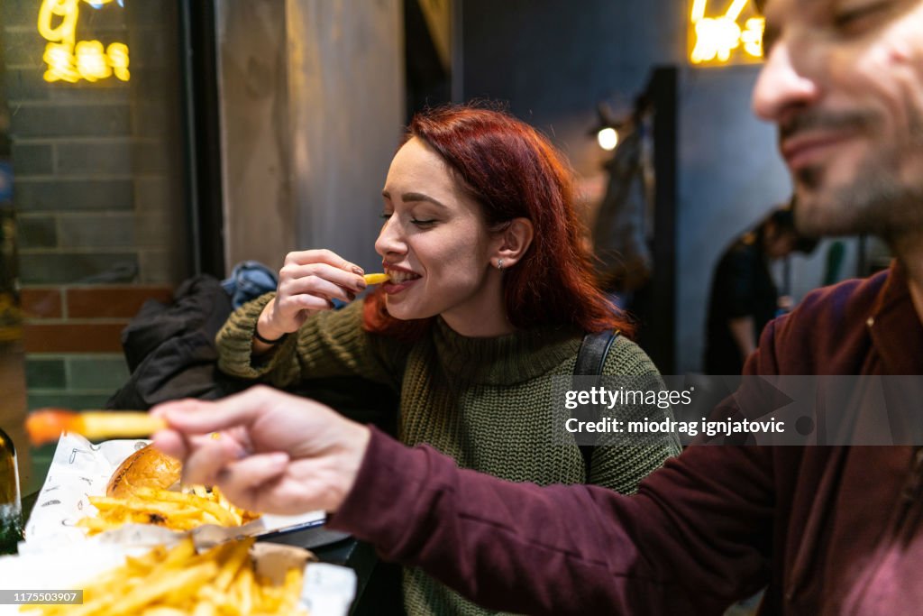 Hungry couple in fast food restaurant