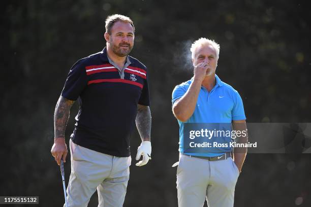 Scott Quinnell and David Ginola look on during the Pro-Am tournament prior to the start of the BMW PGA Championship at Wentworth Golf Club on...