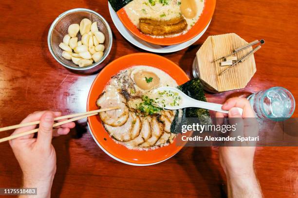 eating ramen with pork and garlic from personal perspective point of view - japanese fat man bildbanksfoton och bilder