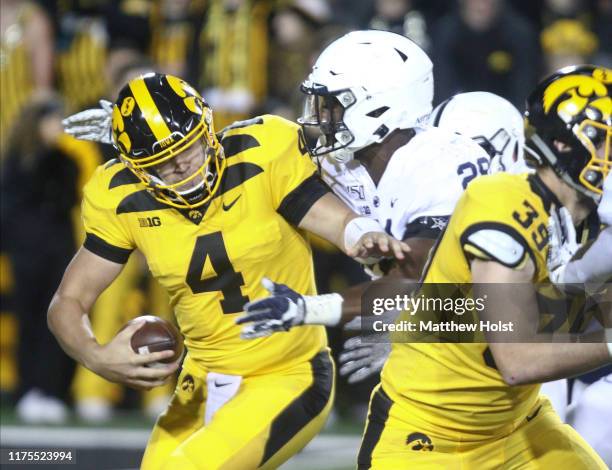 Quarterback Nate Stanley of the Iowa Hawkeyes is sacked during the first half by defensive end Jayson Oweh of the Penn State Nittany Lions on October...