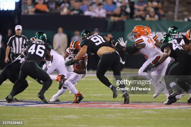 Defensive Lineman Bronson Kaufusi of the New York Jets stops Running Back Nick Chubb of the Cleveland Browns in the first half at MetLife Stadium on...