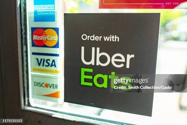 Close-up of logo for Uber Eats on the window of a restaurant in Walnut Creek, California, September 16, 2019.