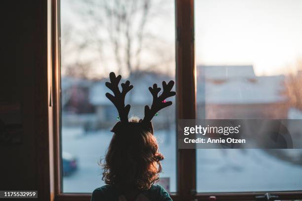 girl with reindeer antlers window - solitude stock pictures, royalty-free photos & images