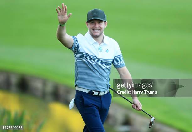 Niall Horan waves to the crowd during the BMW PGA Championship Pro-Am at Wentworth Golf Club on September 18, 2019 in Virginia Water, United Kingdom.
