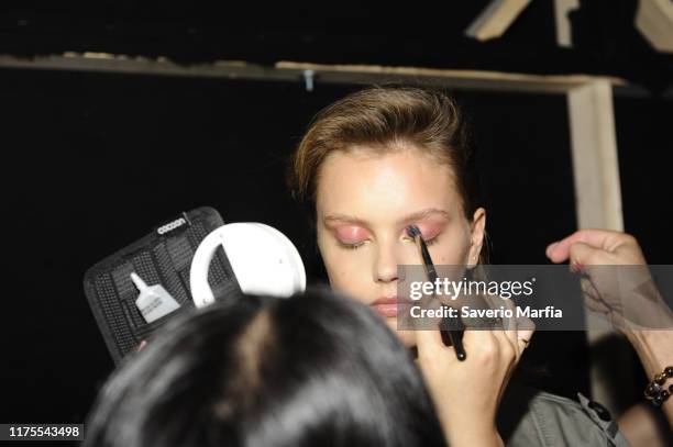 Model prepares backstage for Annakiki fashion show during the Milan Fashion Week Spring/Summer 2020 on September 18, 2019 in Milan, Italy.