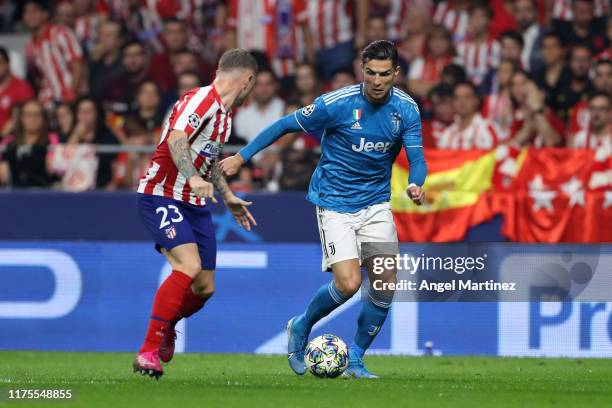 Cristiano Ronaldo of Juventus runs at Kieran Trippier of Atletico Madrid during the UEFA Champions League group D match between Atletico Madrid and...