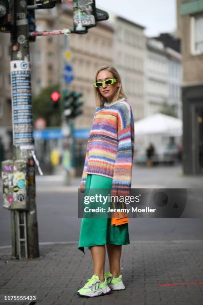 Sonia Lyson wearing Adidas Ozweego Sneaker, Gucci sunglasses, Jacquemus bag, Edited sweater and Zara skirt on September 13, 2019 in Berlin, Germany.