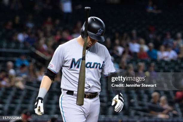 Neil Walker of the Miami Marlins reacts after striking out in the first inning of the MLB game against the Arizona Diamondbacks at Chase Field on...