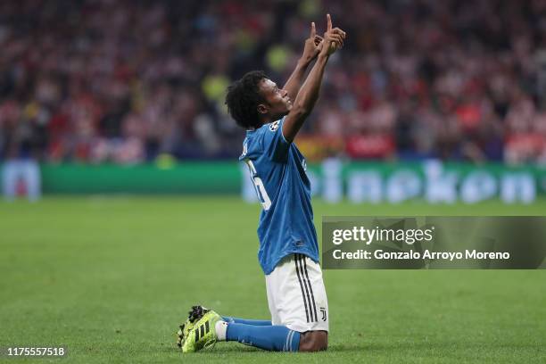 Juan Cuadrado of Juventus celebrates after scoring his sides first goal during the UEFA Champions League group D match between Atletico Madrid and...