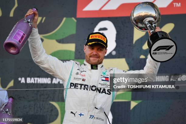 Mercedes' Finnish driver Valtteri Bottas celebrates his victory on the podium after the finish of the Formula One Japanese Grand Prix final at Suzuka...