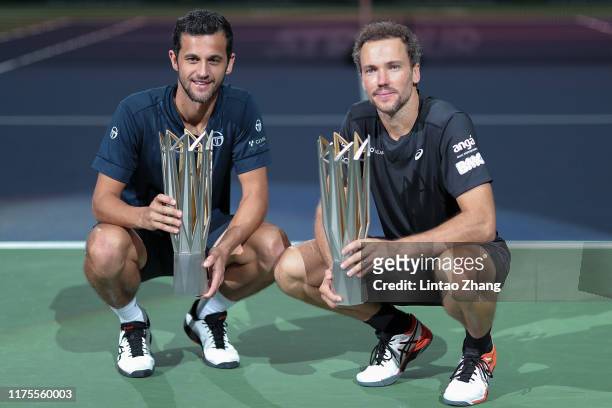 Mate Pavic of Croatia and Bruno Soares of Brazil celebrate with trophy during the Award Ceremony after winning the Men's doubles final match against...
