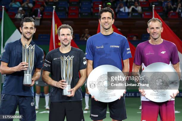 Mate Pavic of Croatia, Bruno Soares of Brazil, Marcelo Melo of Brazil and Lukasz Kubot of Poland celebrate with their trophy during the Award...