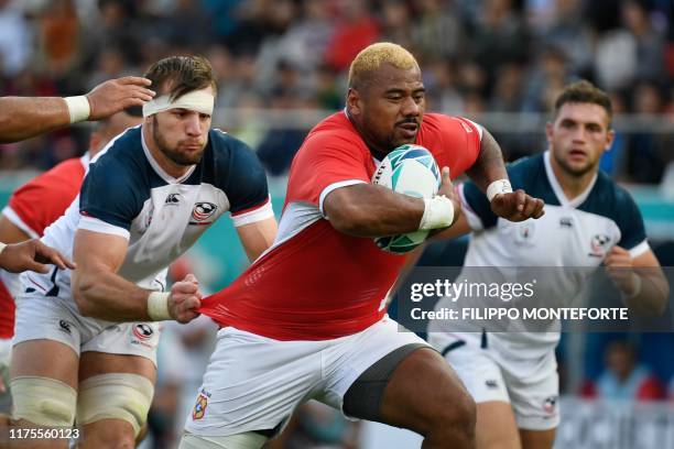 Tonga's hooker Paula Ngauamo runs past US number 8 Cam Dolan during the Japan 2019 Rugby World Cup Pool C match between the United States and Tonga...