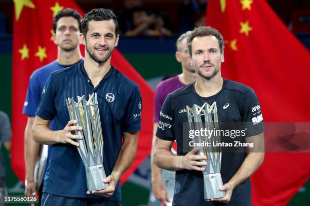 Mate Pavic of Croatia and Bruno Soares of Brazil celebrate with trophy during the Award Ceremony after winning the Men's doubles final match against...