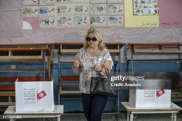 Tunisians voters cast their ballot at a polling station in Tunis, Tunisia on October 13, 2019 during the second round of the presidential election....