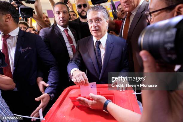 Tunisian presidential candidate, Media mogul Nabil Karoui casts his ballot during the second round of the presidential election on October 13, 2019...