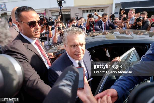 Tunisian presidential candidate, Media mogul Nabil Karoui is talking to media after he casts his ballot during the second round of the presidential...