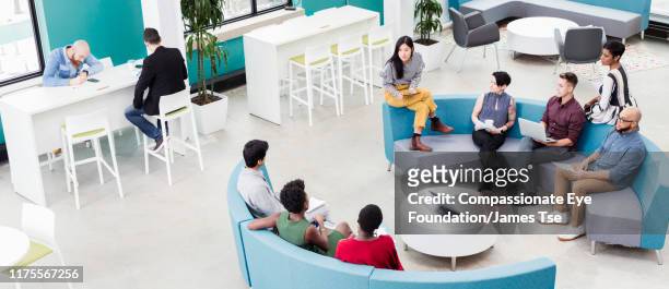 business people having informal meeting in modern open plan office - gender diversity stock pictures, royalty-free photos & images