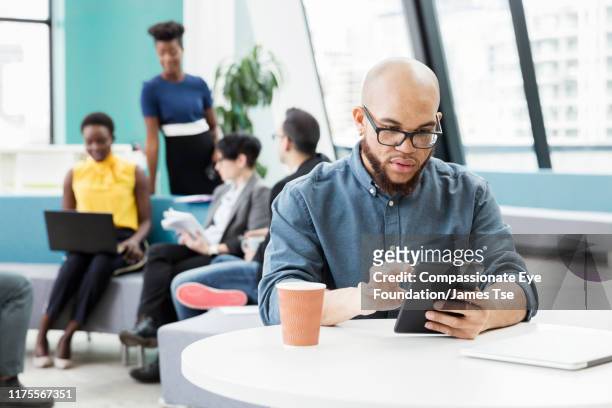 businessman using digital tablet in modern open plan office - cef do not delete stock pictures, royalty-free photos & images
