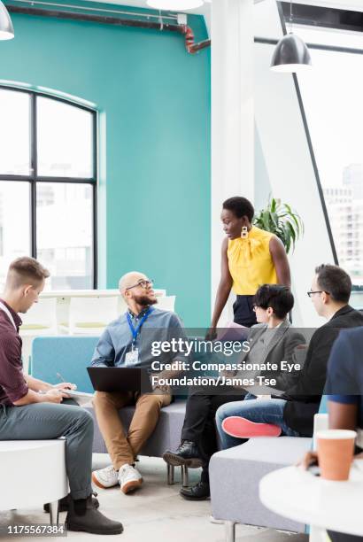 business people having informal meeting in modern open plan office - community development stock pictures, royalty-free photos & images