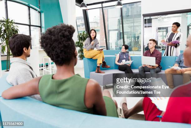 businesswoman leading informal meeting in modern open plan office - creative occupation stock pictures, royalty-free photos & images