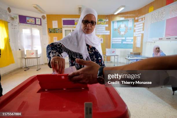 Woman casts her ballot at a polling station during the second round of the presidential election on October 13, 2019 in Tunis, Tunisia. The...