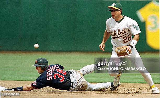 Minnesota Twins Terry Steinbach slides safely into second base as Oakland Athletics shortstop Rafael Bournigal loses the ball during the first inning...