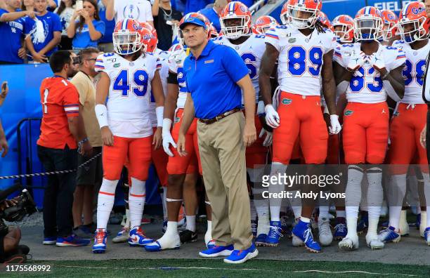 Dan Mullen the head coach of the Florida Gators leads his team on the field before the game against the Kentucky Wildcats at Commonwealth Stadium on...